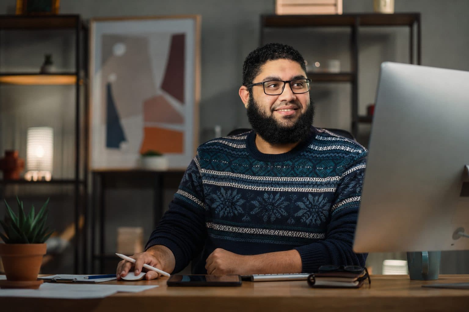 Hossam Mokhtar, Digital Product & UX Consultant, working at his desk